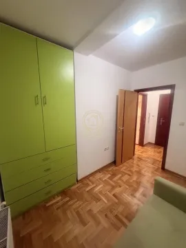 Small room with a green wardrobe, parquet flooring and an open door. - image 10