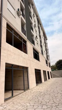 Exterior of a modern residential building with a paved courtyard. - image 2