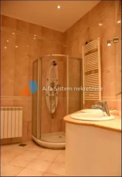 Tiled bathroom with a shower cabin and a washbasin. - image 21