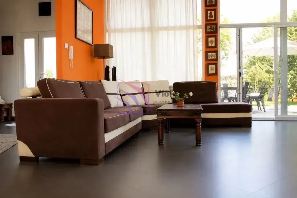 Spacious living room with a sofa set and access to the terrace.