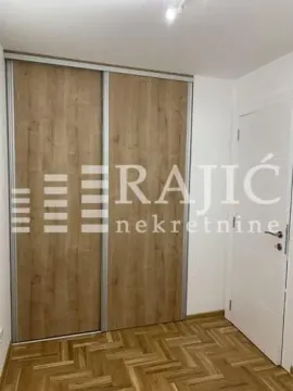 View of a built-in wardrobe with a wood finish in the room. - image 8