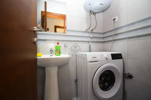 Small bathroom with a washbasin, washing machine and a water heater on the wall. - image 10