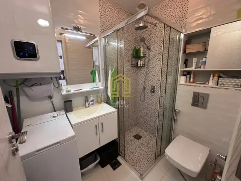 Modernly equipped bathroom with a shower cabin, washbasin, and washing machine. - image 10
