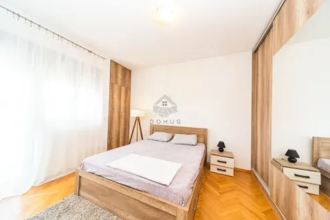 Furnished bedroom with a double bed and wooden wardrobes. - image 6