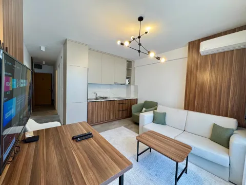 Living room with a sofa set, kitchen in the background, and a dining table. - image 4