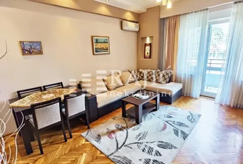 Living room with a sofa set, dining table, and access to the terrace. - image 2