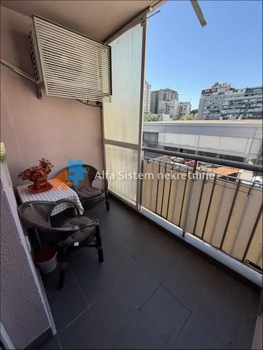 Natkriveni balkoni sa garniturom za sedenje i pogledom na grad.