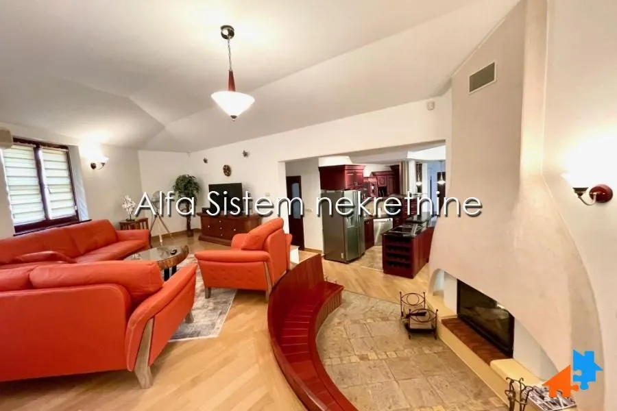 Spacious living room with seating furniture and a fireplace.