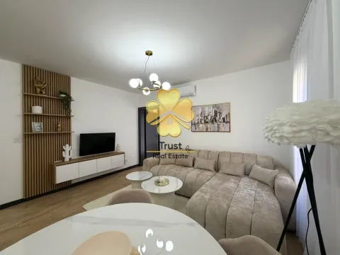 Modern living room with a sofa, TV, and dining table. - image 4