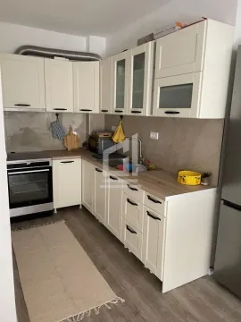 Kitchen with white cabinetry, wooden countertops, and a stove. - image 6