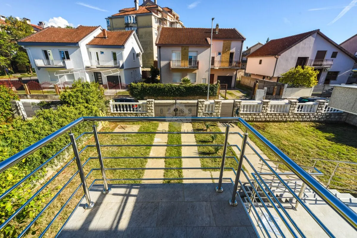 View from the balcony overlooking the yard and surrounding houses.