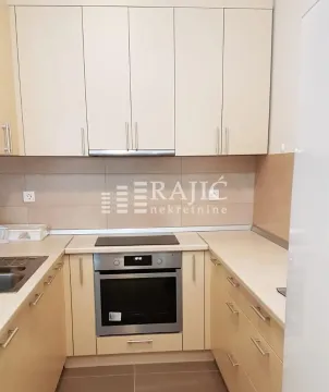 Small kitchen with built-in cabinetry and an oven. - image 5