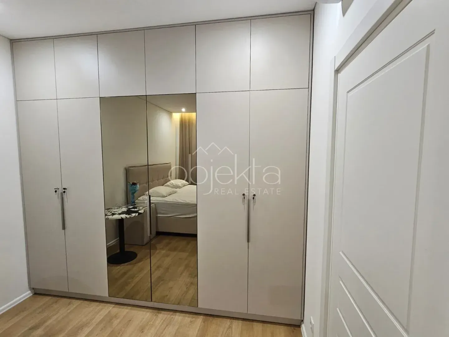 Veliki bijeli garderober sa ogledalom u spavaćoj sobi.