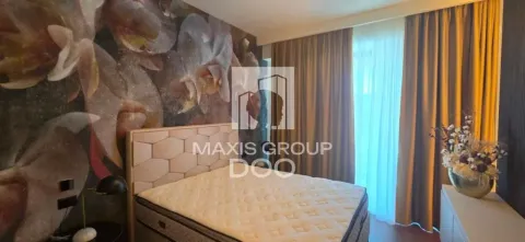 Furnished bedroom with a double bed and a patterned wall. - image 8