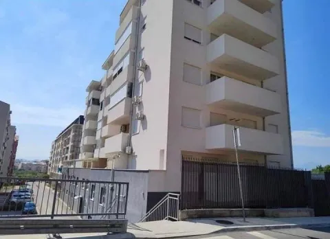 Exterior view of a residential building with balconies and surrounding road. - image 6