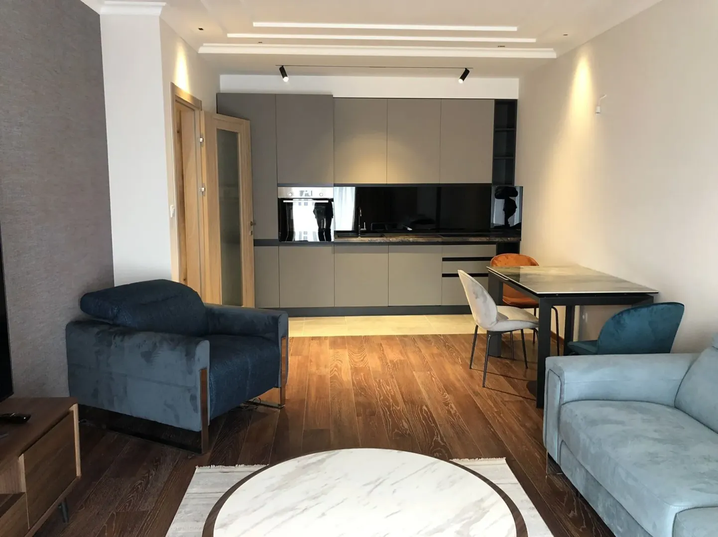 Bright open-concept living room with a modern kitchen and dining area.