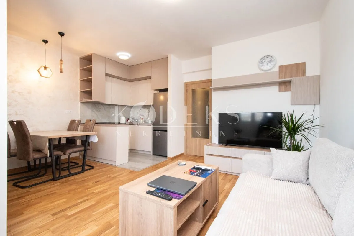 Living room with dining area and kitchen in an open-plan space.