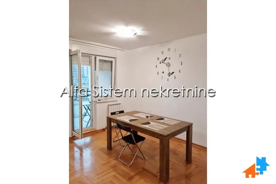 Dining area with a wooden table and chairs, with access to the terrace.