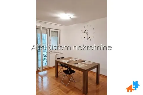 Dining area with a wooden table and chairs, with access to the terrace. - image 17