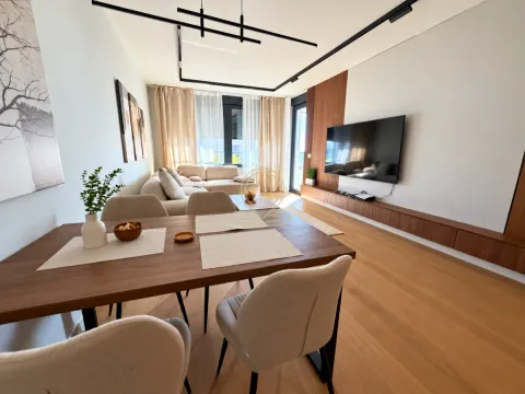 Modern living room with a dining area and a TV unit. - image 9