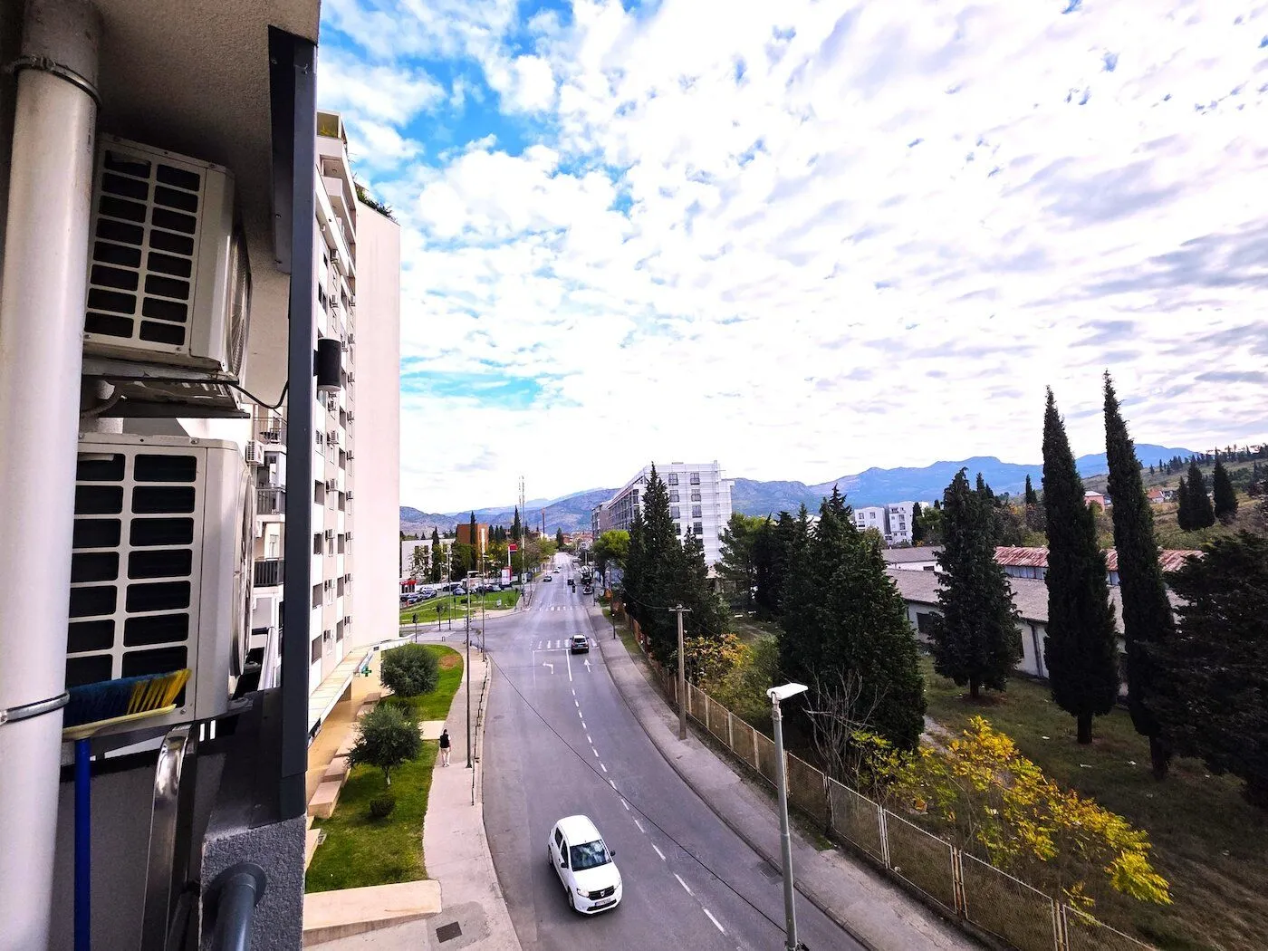 View from the terrace towards the street and surrounding buildings.