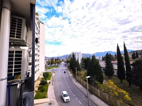 View from the terrace towards the street and surrounding buildings. - image 15