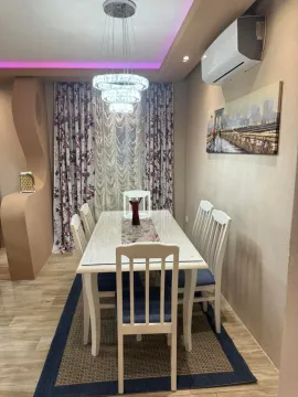 Dining room with table, chairs, and chandelier. - image 4