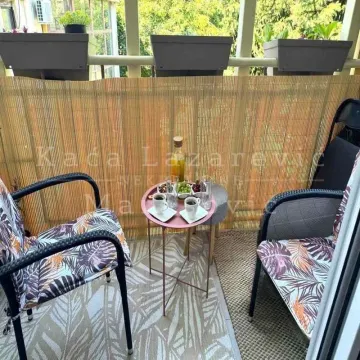 Furnished balcony with seating set and a small table. - image 5