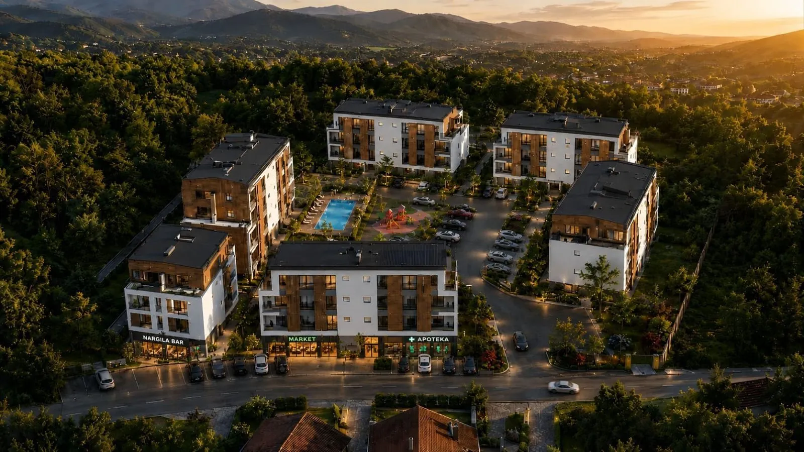 Pogled iz vazduha na stambeni kompleks sa bazenom i pratećim objektima.