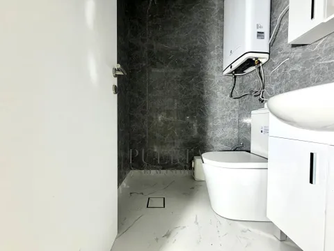 Small bathroom with white sanitary ware and grey marble tiles. - image 13