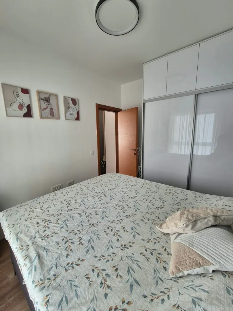 Furnished bedroom with a large double bed and built-in wardrobe.
