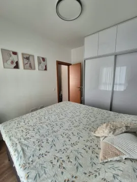 Furnished bedroom with a large double bed and built-in wardrobe. - image 10