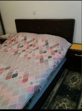 A bedroom with a double bed. - image 3