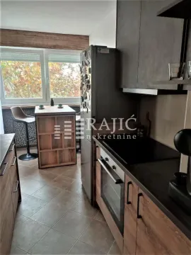 Modern kitchen with a dining area by the window. - image 4