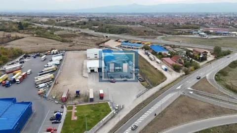 Aerial view of a business complex with warehouses and parked trucks. - image 9