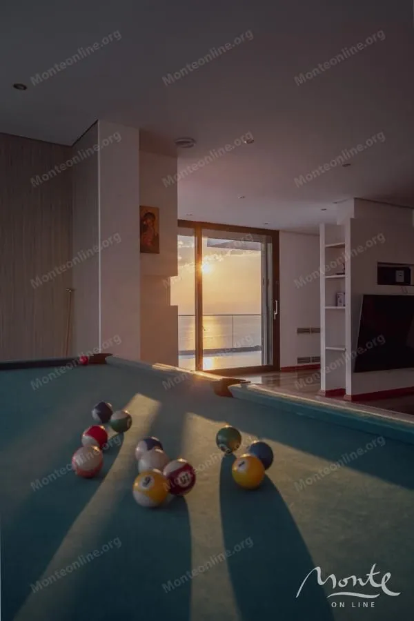 Living room with a billiard table and sea view.