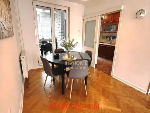 Dining area with a dining table and chairs, with a view of the kitchen and terrace. - image 2