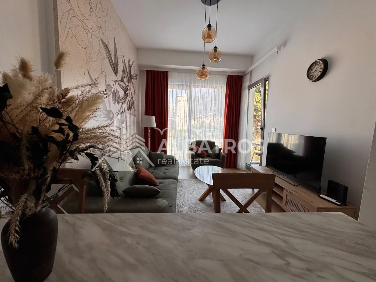 Living room with sofa, TV, and access to the terrace.