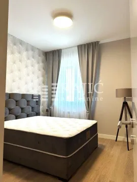 Modern bedroom with a double bed and accent wallpaper. - image 7