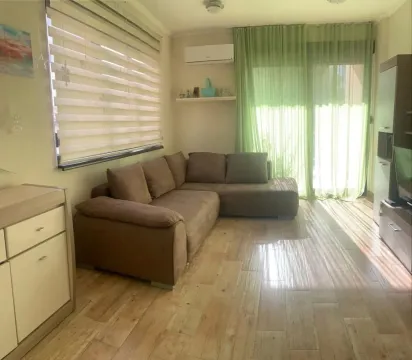 Living room with a corner sofa, TV unit and a large window. - image 4