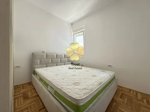 Bright bedroom with a double bed and parquet flooring. - image 9