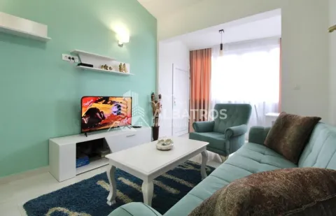 Living room with sofa, coffee table and television. - image 3