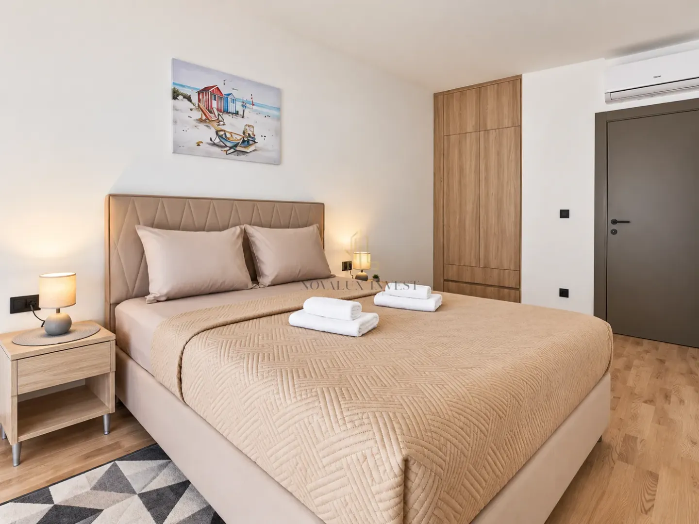 Furnished bedroom with a double bed, bedside tables, and a built-in wardrobe.