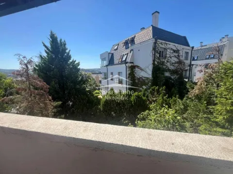 View from the terrace overlooking the neighbouring building and green areas. - image 3