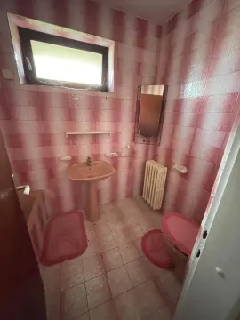 Starije kupatilo sa roze pločicama, umivaonikom i wc šoljom. - image 24