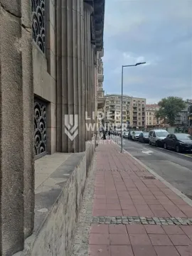View of the street with a sidewalk in front of the building. - image 14