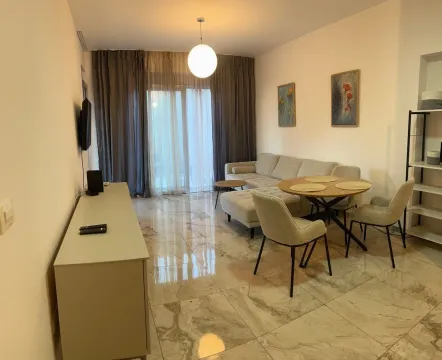 Living room with a sofa, dining table, and access to the terrace. - image 6