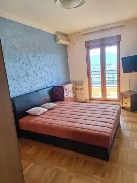 Bedroom with a double bed, blue accent wall, and access to the terrace. - image 4