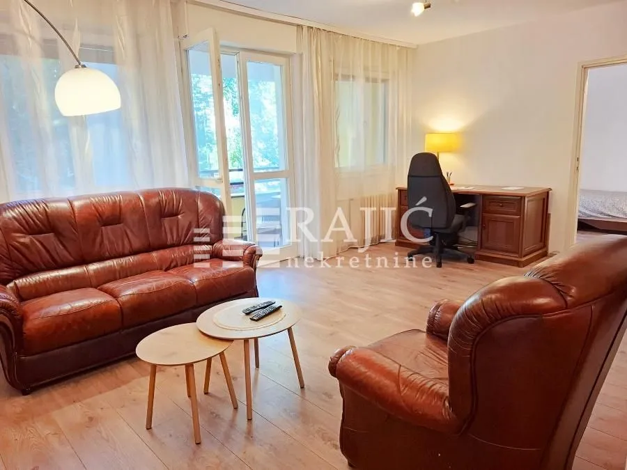 Living room with leather furniture and a desk.
