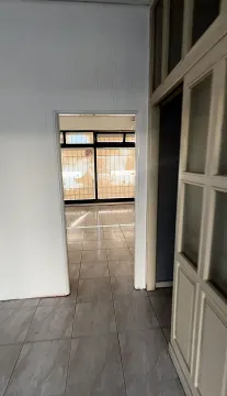 A view through a doorway into an empty space with tiled flooring. - image 5